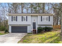 Charming two-story home with gray siding, black shutters, and an attached two-car garage at 3456 Lenora Church Rd, Snellville, GA 30039