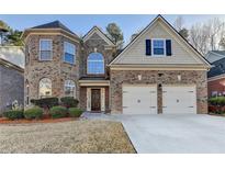 Charming brick two-story home with attached two-car garage and manicured front yard at 3379 Rosecliff Trce, Buford, GA 30519