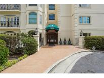 Elegant building entrance with manicured landscaping and a covered awning with address at 3636 Peachtree Ne Rd # 405, Atlanta, GA 30319