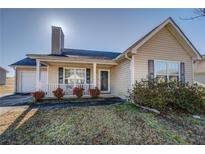 Charming single-Gathering home with a cozy front porch and well-maintained landscaping at 6661 Gina Agha Cir, Lithonia, GA 30038