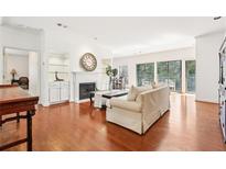 Bright living room boasts a fireplace, hardwood floors, built-in shelves, and access to outdoor space at 3071 Lenox Ne Rd # 11, Atlanta, GA 30324