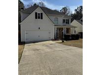 Charming two-story home features a two-car garage and inviting covered porch at 2162 Fall Creek Ldg, Loganville, GA 30052