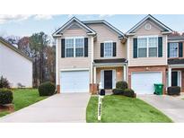 Inviting townhome features a well-manicured lawn, a one-car garage, and a charming front entrance at 3682 Harvest Dr, Decatur, GA 30034