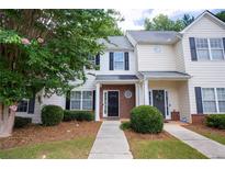 Charming townhouse featuring a well-maintained lawn and a welcoming front entrance at 2763 Snapfinger Mnr, Decatur, GA 30035