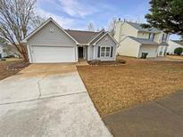 Charming single-story home featuring a two-car garage and a well-maintained front yard at 2328 Wavetree Nw Ln, Acworth, GA 30101