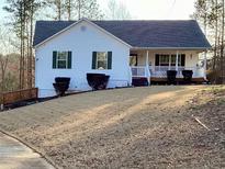 Charming one-story home with vinyl siding, a covered porch and a well-maintained front yard at 140 Thrasher Rd, Covington, GA 30016
