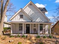 Charming home with a inviting front porch, landscaped yard, and stone walkway leading to the front door at 267 Connecticut Ne Ave, Atlanta, GA 30307
