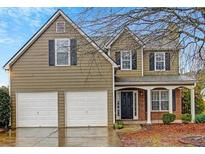 Charming two-story home featuring a two-car garage, covered porch, and a classic design with black shutters at 3925 Keystone Nw Rdg, Acworth, GA 30101