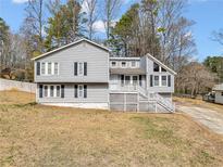 Charming two-story home with gray siding, a front porch, and a well-maintained lawn at 25 Pine Ferry Nw Dr, Kennesaw, GA 30144