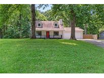 Charming home features a red front door, dormer windows, and a two-car garage at 277 Hope Dr, Dallas, GA 30157