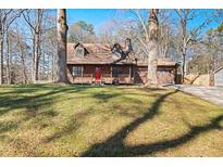 Charming two-story home with a red front door, a covered porch, and a well-maintained lawn at 277 Hope Dr, Dallas, GA 30157