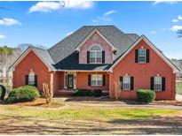 Charming red brick home with manicured landscaping and a walkway to the front entrance at 770 Huiet Dr, Mcdonough, GA 30252