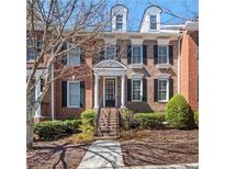 Charming brick townhouse with black shutters and a well-maintained front yard at 5002 Davenport Pl, Roswell, GA 30075
