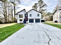 Charming two-story home with a well-maintained lawn and a double garage at 295 Lamden Ct, Lawrenceville, GA 30046