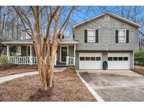 Charming two-story home with gray siding, a covered porch, and a two-car garage at 79 Mountain View Ct, Dallas, GA 30157