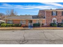 Charming brick townhouse featuring a well-maintained front yard and a welcoming entrance at 1657 Executive Park Ne Ln, Atlanta, GA 30329