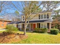 Charming two-story home features a well-maintained lawn and mature trees at 4081 Deerwood Se Pkwy, Smyrna, GA 30082