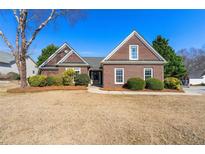 Charming single-story brick home with well-manicured landscaping and a welcoming entrance at 2955 Victoria Park Dr, Buford, GA 30519