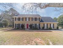 Charming two-story home with black shutters and a welcoming red front door at 1953 Graystone Pkwy, Grayson, GA 30017