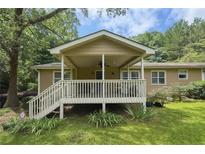 Inviting covered back porch with stairs and ceiling fan, perfect for outdoor relaxation at 1537 David Lee St, Acworth, GA 30102