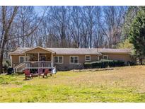 Charming single story home with covered porch and lush green lawn at 1537 David Lee St, Acworth, GA 30102