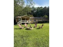 Relaxing front yard with a fire pit and a circle of Adirondack chairs at 1537 David Lee St, Acworth, GA 30102