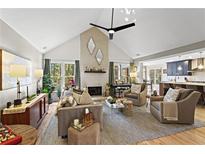 Bright living room featuring a fireplace, vaulted ceilings, and lots of natural light at 1820 N Creek Cir, Alpharetta, GA 30009
