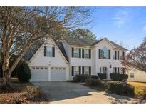 Traditional two-story home with a two-car garage and manicured landscaping at 2524 Columbia Crossing Ct, Decatur, GA 30034