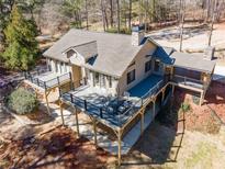 Stunning home with a spacious deck for outdoor dining and entertaining, nestled among the trees at 1655 Butler Bridge Rd, Covington, GA 30016