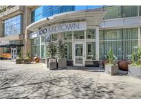 Stylish entrance of 1010 Midtown building featuring modern architecture and lush landscaping at 1080 Peachtree Ne St # 2003, Atlanta, GA 30309