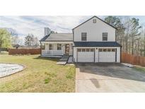 Charming two-story home with a manicured lawn, covered porch, and two-car garage at 785 Josh Ln, Lawrenceville, GA 30045