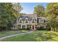 Charming two-story home with stone accents, dormer windows, and a bright red front door at 3814 Vermont Ne Rd, Atlanta, GA 30319