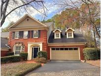 Charming brick home featuring a two-car garage and well-manicured landscaping at 7155 Roswell Rd # 37, Sandy Springs, GA 30328
