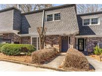 Traditional brick townhome featuring manicured landscaping and a welcoming entrance at 1106 Hampton Ne Way, Atlanta, GA 30324