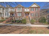 Charming brick townhome with manicured landscaping and inviting entryway stairs at 775 Mountain View Nw Ter, Marietta, GA 30064