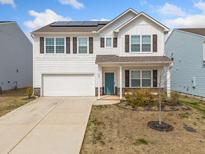 Charming two-story home featuring a welcoming front porch, two car garage and solar panels at 828 Royal Red Ct, Mcdonough, GA 30253