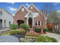 Charming brick home with stone archway, manicured landscaping and inviting front entrance at 1181 Lanier Ne Blvd, Atlanta, GA 30306