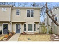 Charming townhome featuring a well-manicured front yard and neutral-tone facade, near a walkway and trees at 1002 Defoors Nw Lndg, Atlanta, GA 30318