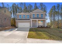 Charming brick two-story home with a two-car garage and manicured front lawn at 129 Belvedere Rd, Mcdonough, GA 30253