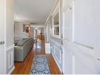 Inviting entryway featuring hardwood floors, neutral walls, and a view into the home's open-concept living space at 135 Cowan Trl, Stockbridge, GA 30281