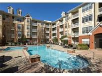 Resort-style pool with sun loungers and tables for relaxation in a beautiful residential community at 1225 Westchester Ne Rdg, Atlanta, GA 30329