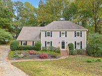 Charming two-story home with a well-manicured lawn and mature landscaping, perfect for suburban living at 1864 Gloucester Ct, Snellville, GA 30078