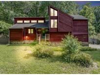 Charming exterior of home with red wood paneling, large windows, and a well-maintained front yard at 2375 Justine Ter, Lithia Springs, GA 30122