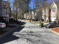 A picturesque street view of townhomes in a peaceful neighborhood with mature trees and well-maintained landscaping at 789 Celeste Sw Ln, Atlanta, GA 30331