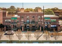 Charming brick building with awnings, balconies, and a wrought iron fence provides a unique urban living experience at 791 Wylie Se St # 105, Atlanta, GA 30316