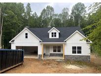 Charming new construction home featuring white siding, stone accents and an attached two car garage at 345 Evie Ln, Canton, GA 30115