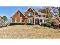 Stately brick home featuring a well-manicured lawn and inviting front porch perfect for relaxing at 4537 Rutherford Dr, Marietta, GA 30062