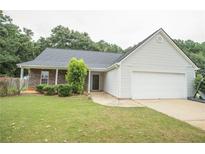 Charming single-story home with a two-car garage and well-manicured lawn at 704 Stonecrest Ln, Loganville, GA 30052