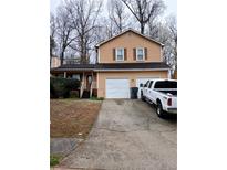 Charming two-story home with a two-car garage and a cozy front porch at 2760 Waterford Park Dr, Lawrenceville, GA 30044