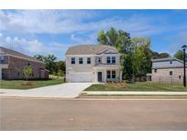 Charming two-story home with a two-car garage and a well-manicured front yard at 237 Chiswick Loop, Stockbridge, GA 30281